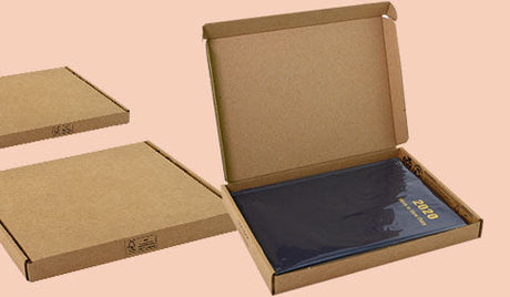 Letterbox Friendly Packaging example, showing open box containing a hardback book. image on a peach coloured background