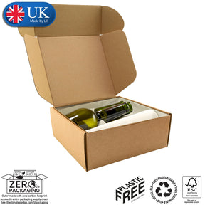 A flat-packed, brown cardboard postal box with dimensions labelled as 34x16x13cm. The box is marked as made by Lil, UK, with a small parcel icon, and includes a label indicating it is plastic-free and made from recycled materials.