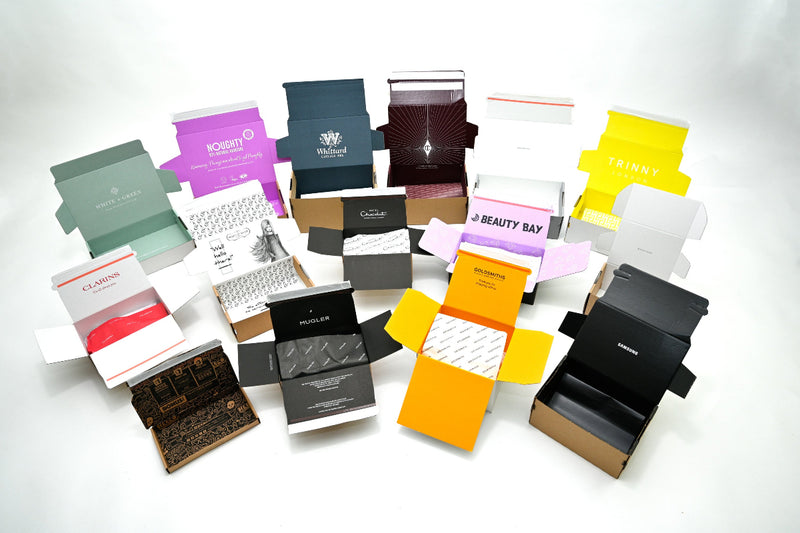 display image of sample lil packaging ecommerce breezebox boxes that are open and show the various brands including clarins, mugler and beauty bay