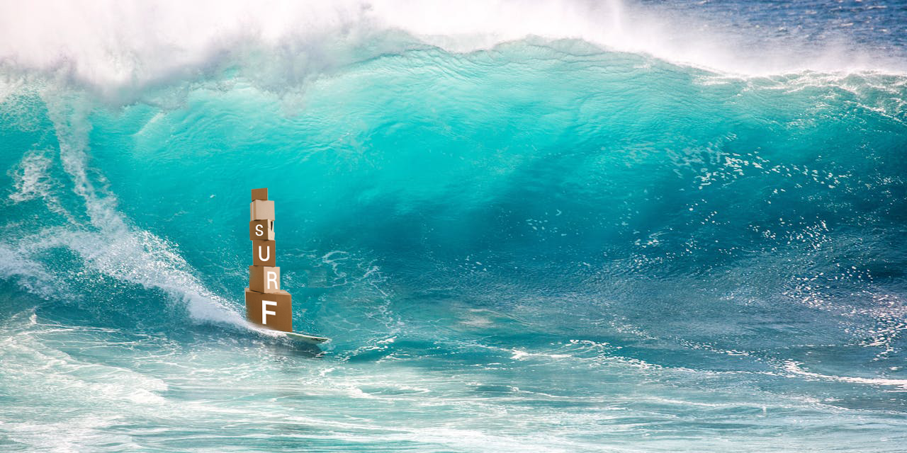 Large wave crashing over a surfboard with 'SURF' sign in the foreground